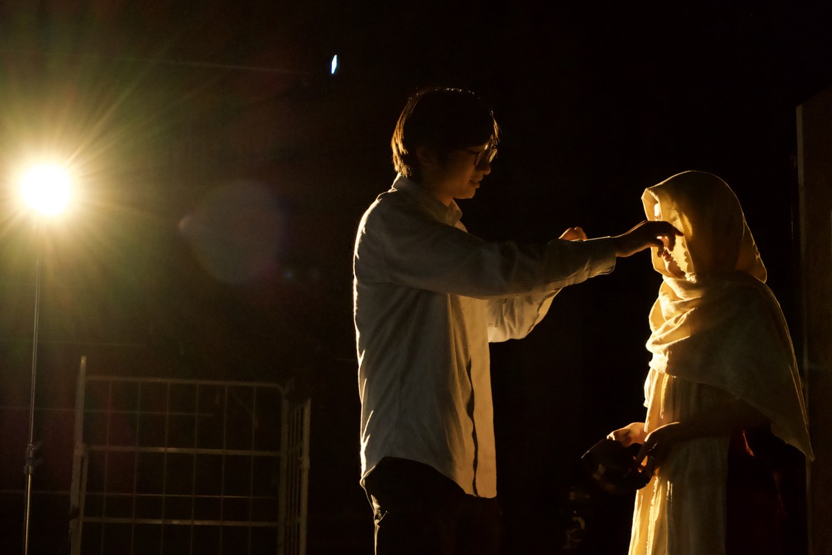 his hand at her veiled face, lamp flaring