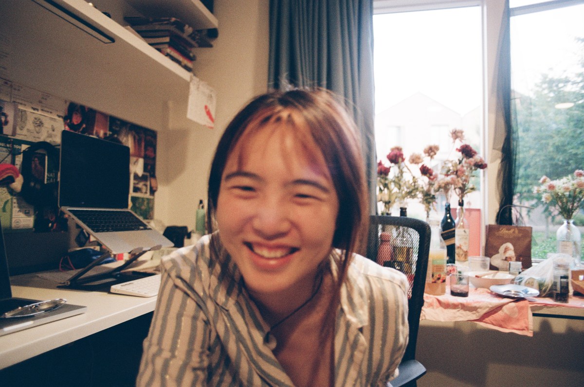 laughing with eyes shut, backlit window